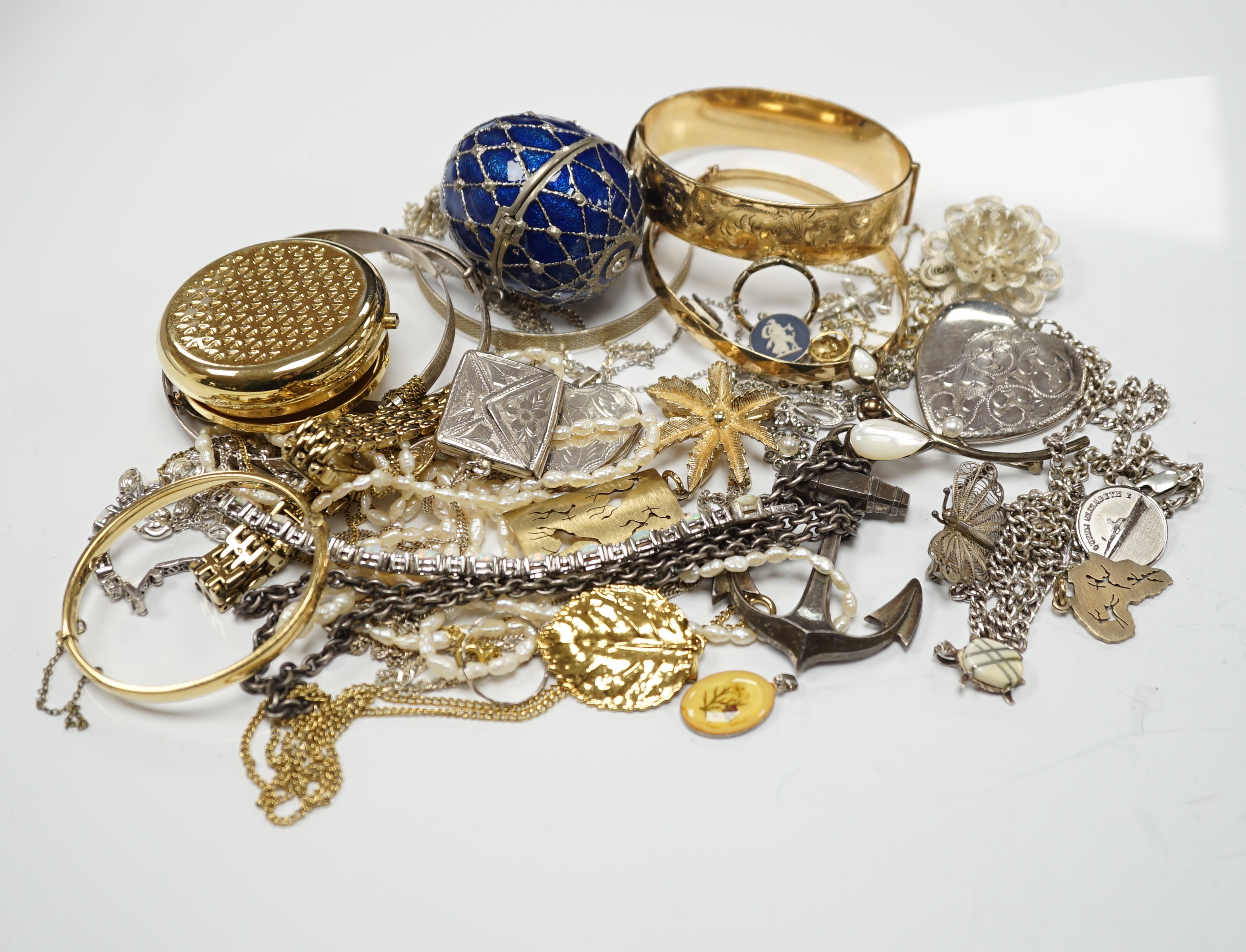 A quantity of assorted costume and silver jewellery including pendants, locket, bracelets, bangles, chains etc.
